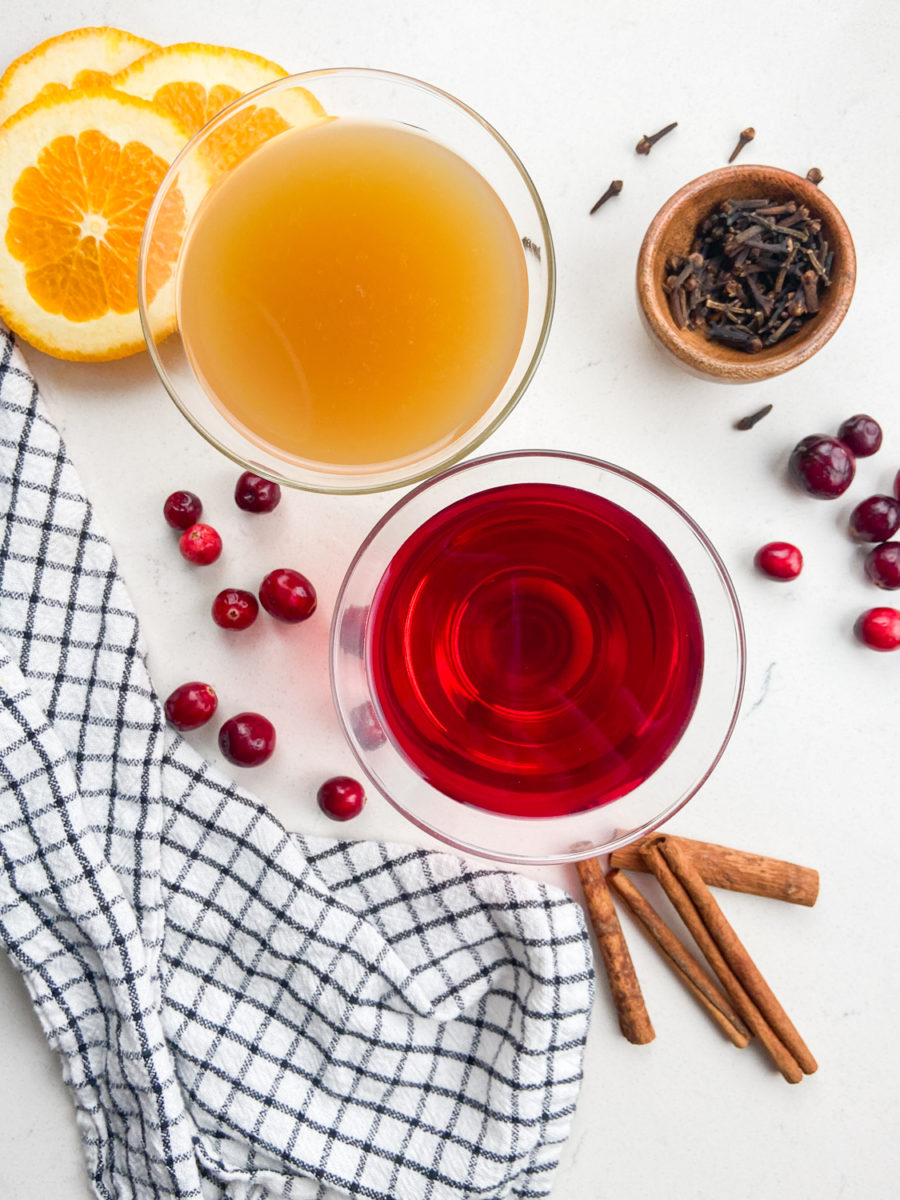 Overhead photo of ingredients needed to make hot apple cranberry cider. 