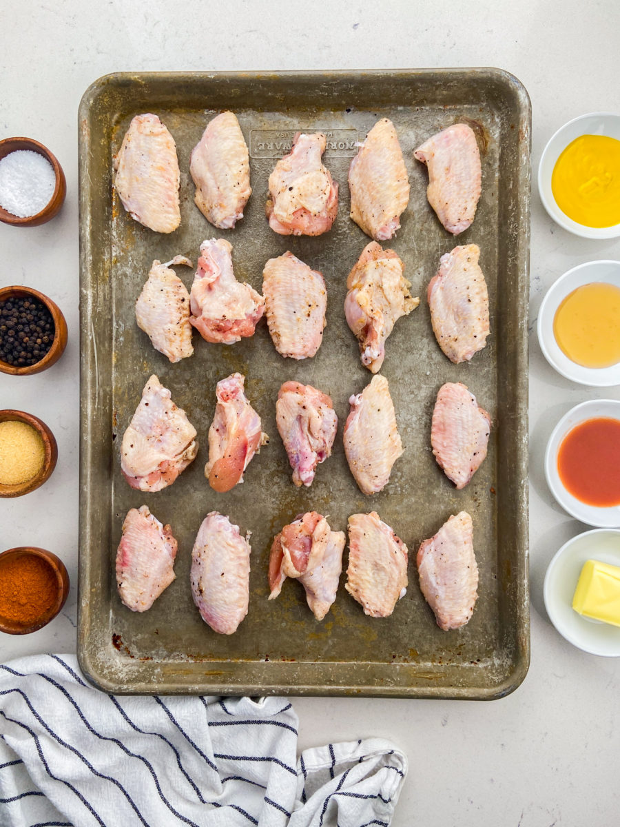 Chicken wings on baking sheet. 