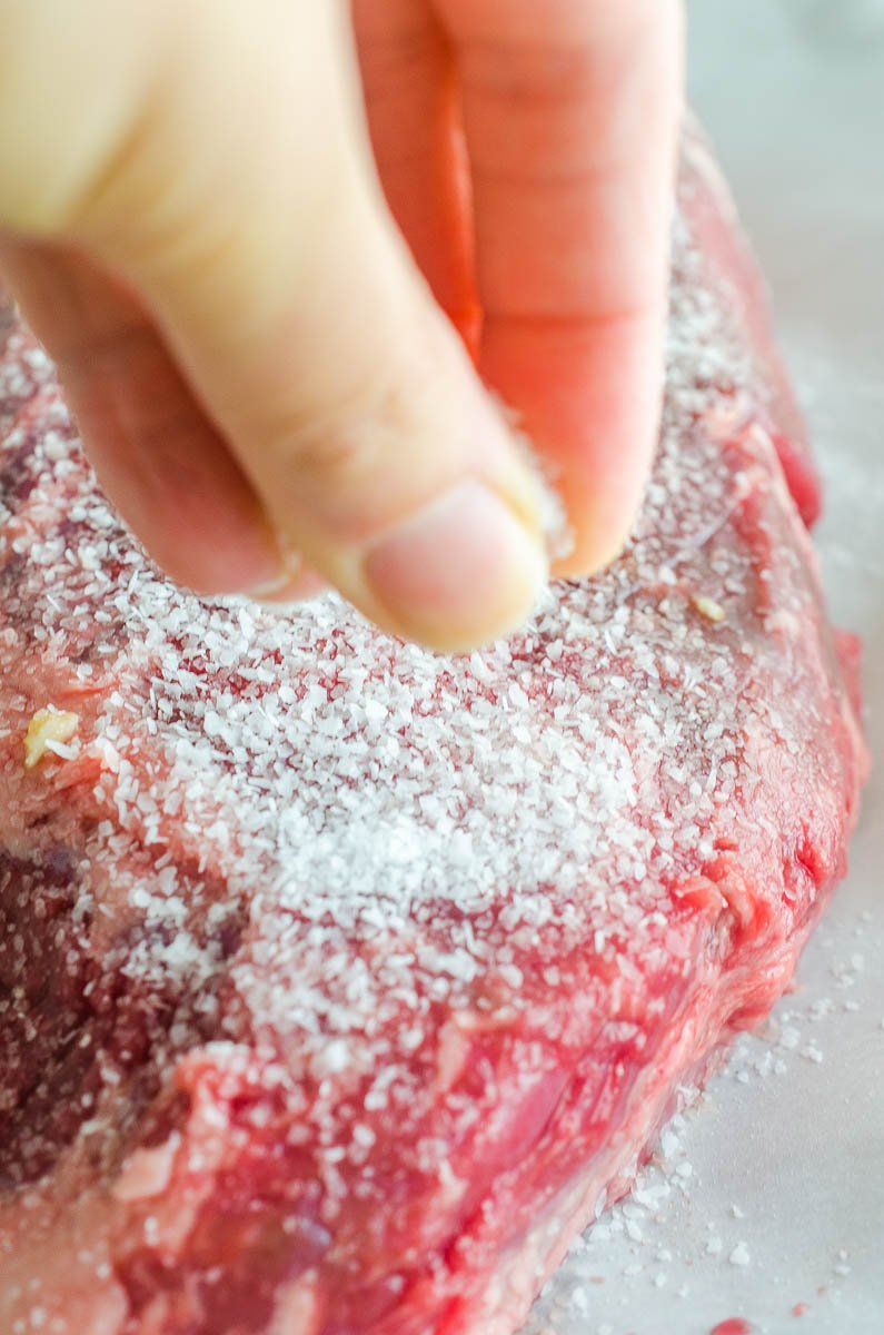 Sprinkling salt on steak