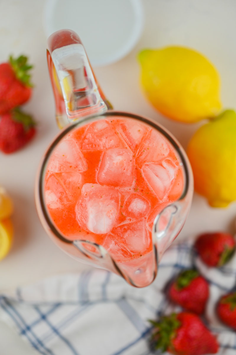 Overhead photo looking into the pitcher of strawberry lemonade. 