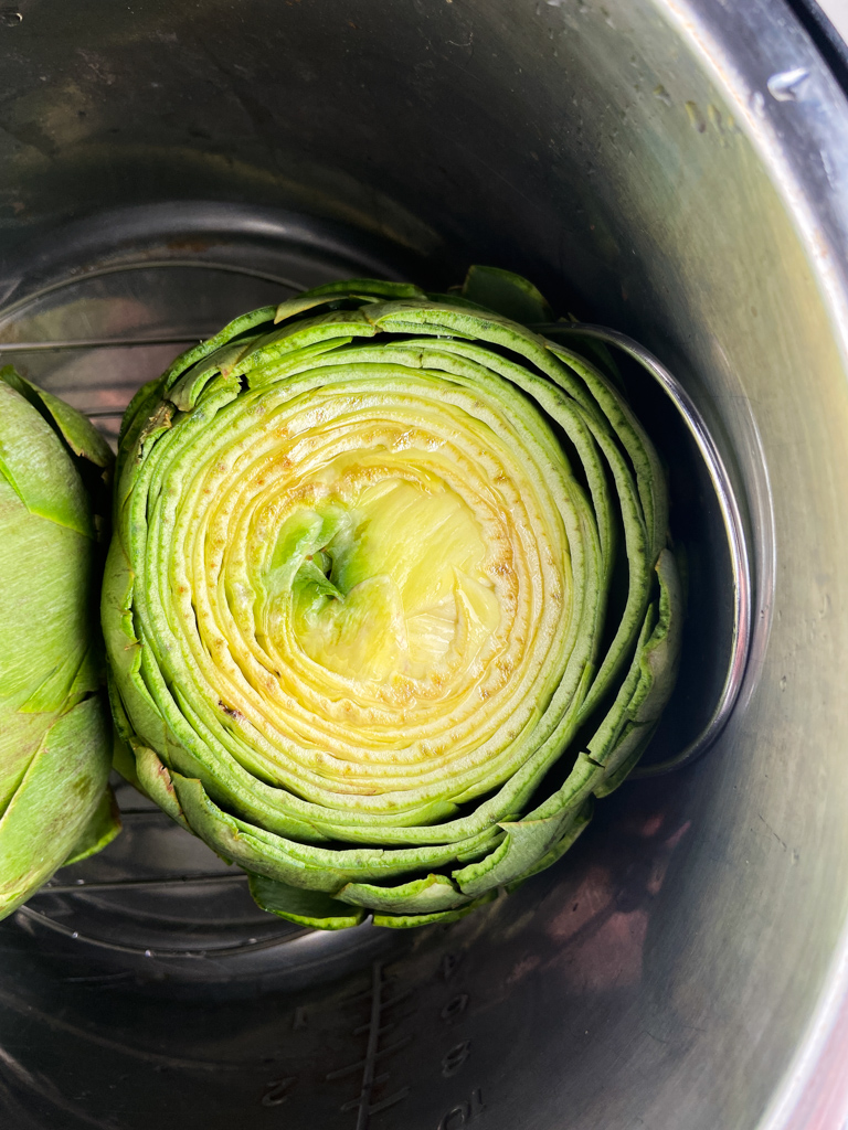 Raw whole artichoke inside an instant pot. 