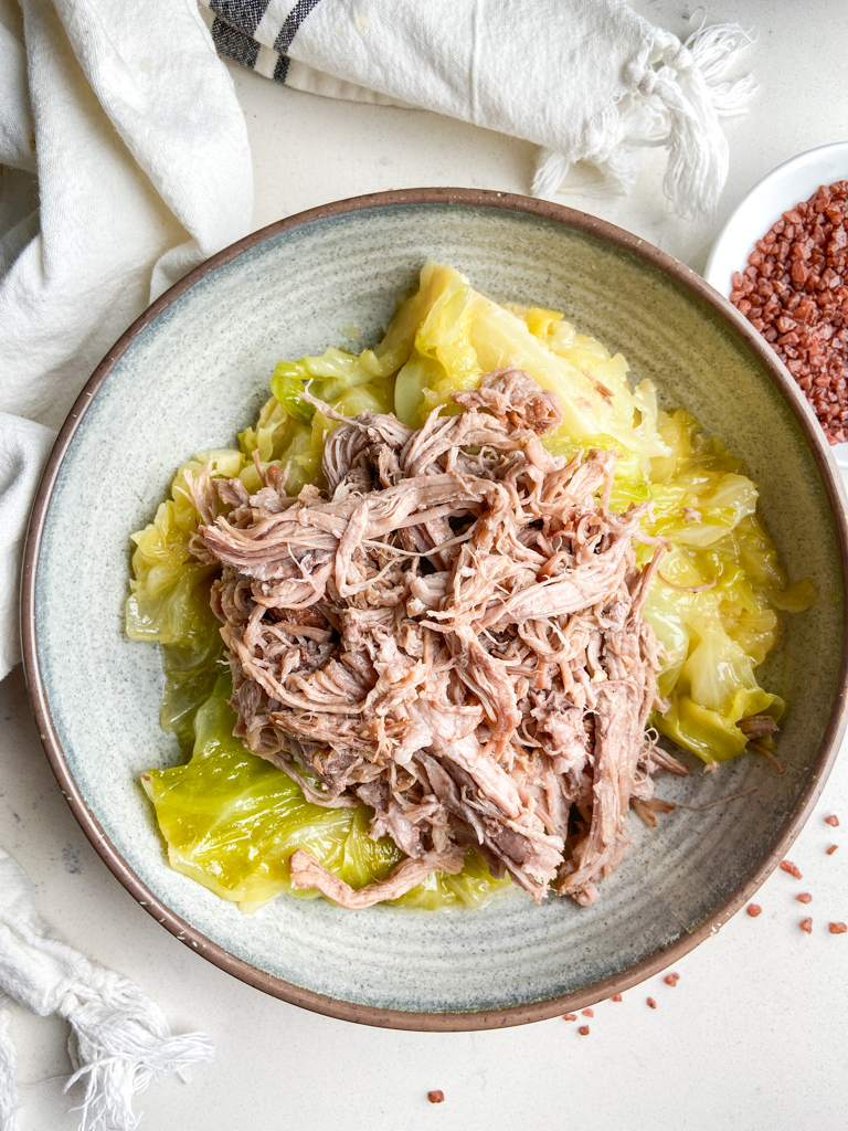 Overhead photo of kalua pork and cabbage in a bowl. 