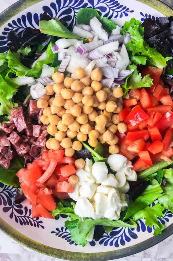 Italian chopped salad LOADED with salami, mozzarella and veggies all tossed in a tangy balsamic dijon vinaigrette.