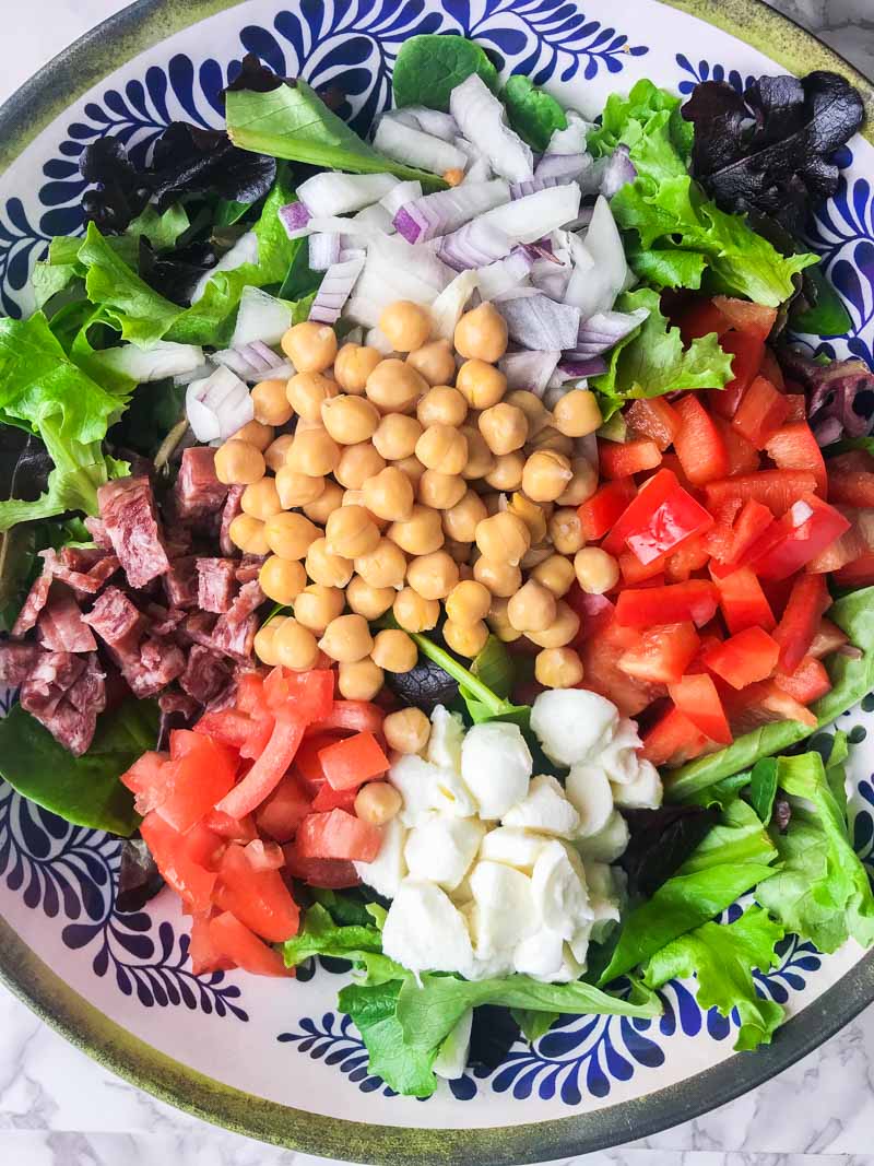 Italian chopped salad LOADED with salami, mozzarella and veggies all tossed in a tangy balsamic dijon vinaigrette.