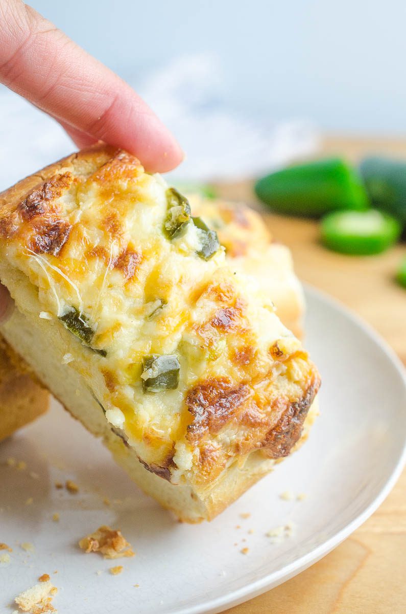 Jalapeno Popper Cheese Bread is everyone's favorite happy hour snack in cheese bread form. Spicy jalapenos, 3 different cheeses and crusty bread. It doesn't get much better! 