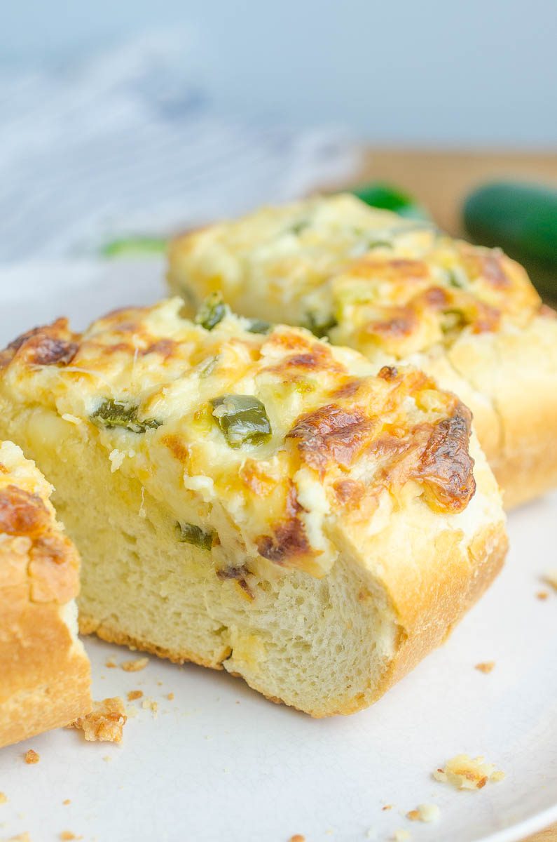 Jalapeno Popper Cheese Bread is everyone's favorite happy hour snack in cheese bread form. Spicy jalapenos, 3 different cheeses and crusty bread. It doesn't get much better! 