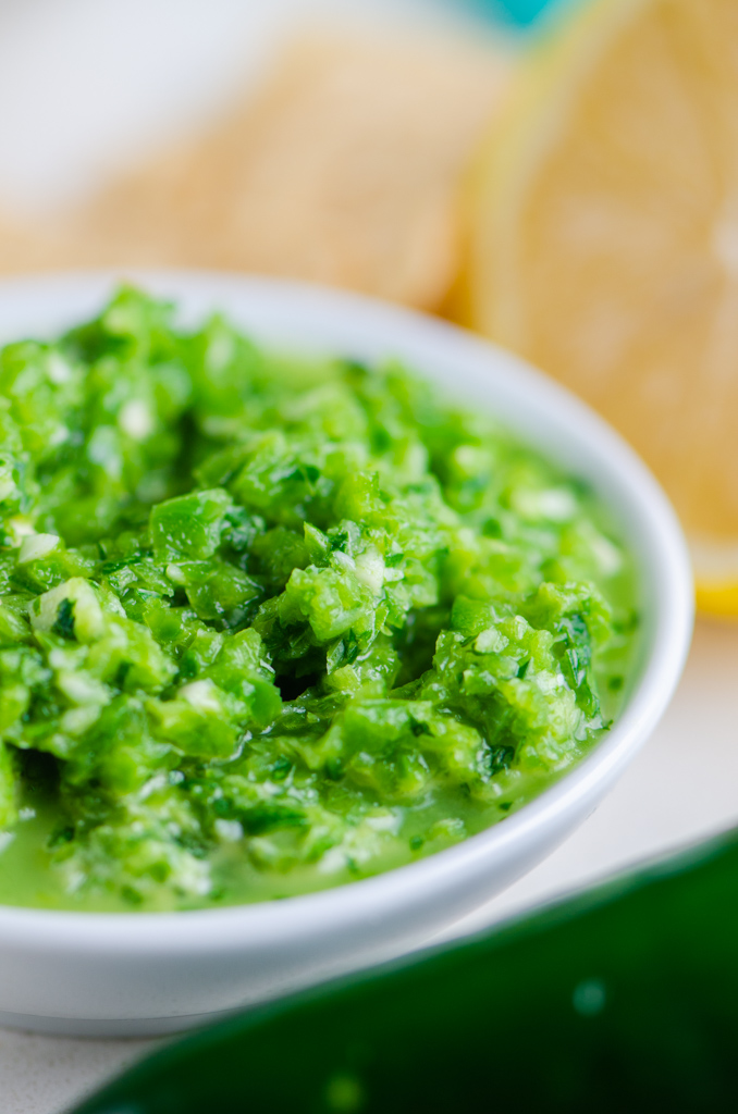 Close up side photo of jalapeno salsa in a white bowl. 