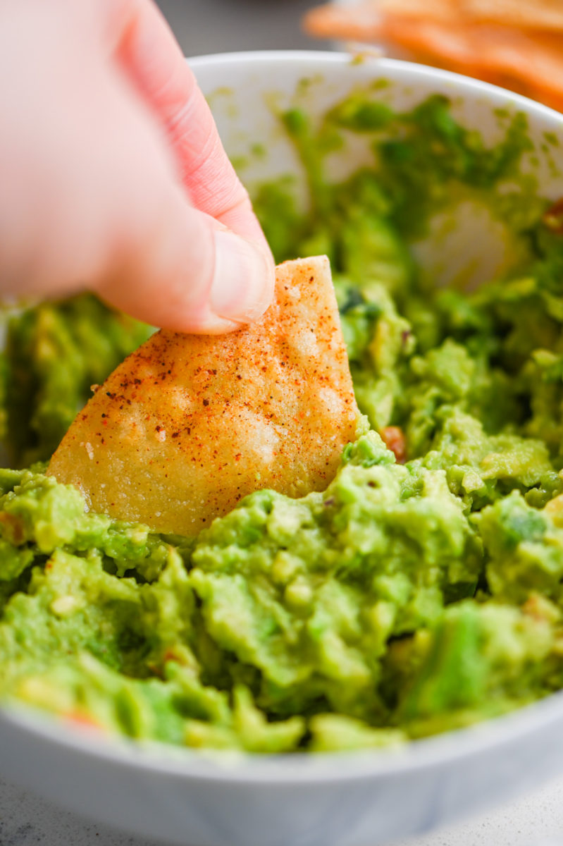 Dipping chip in guacamole. 