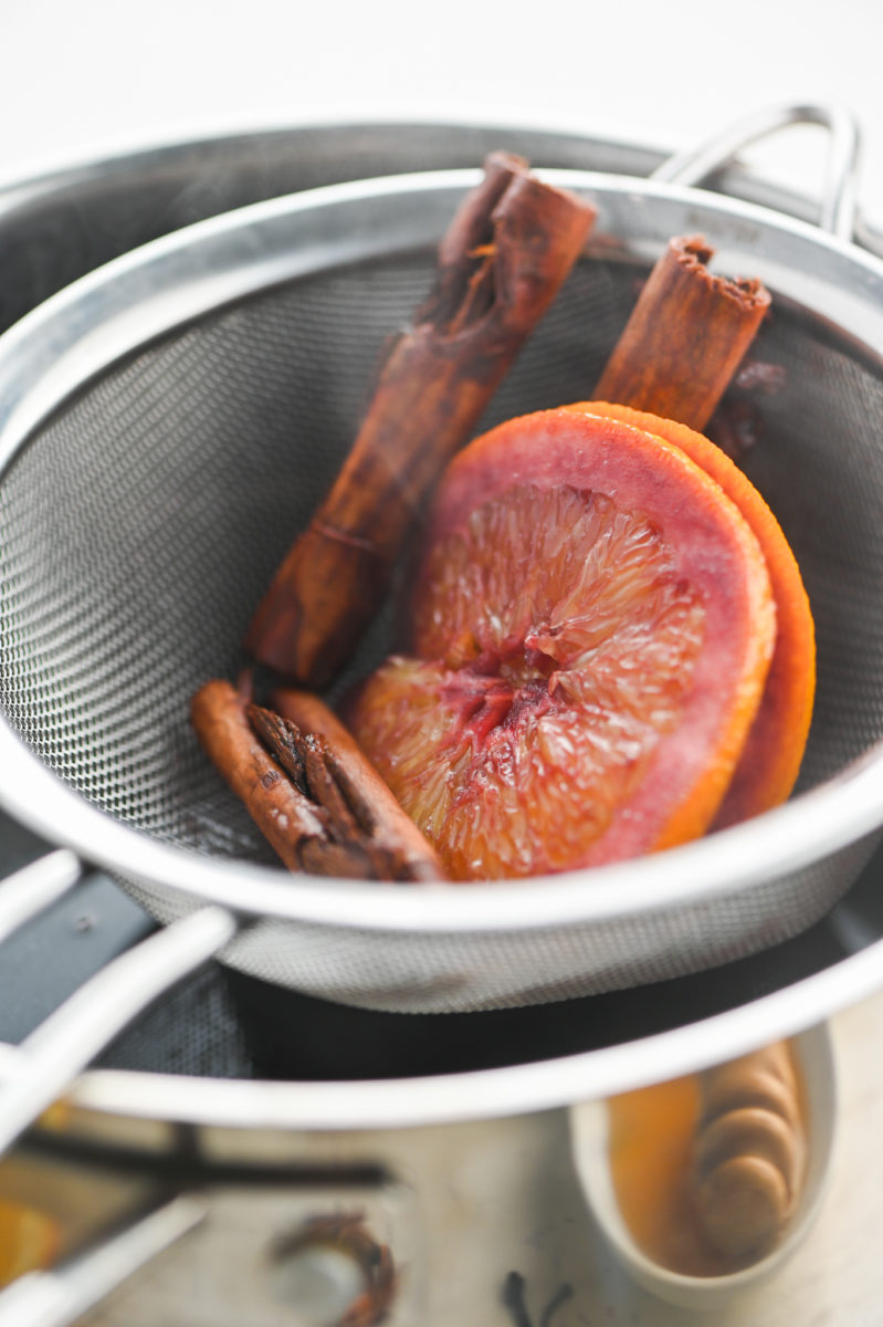 Straining aromatics from mulled wine. 