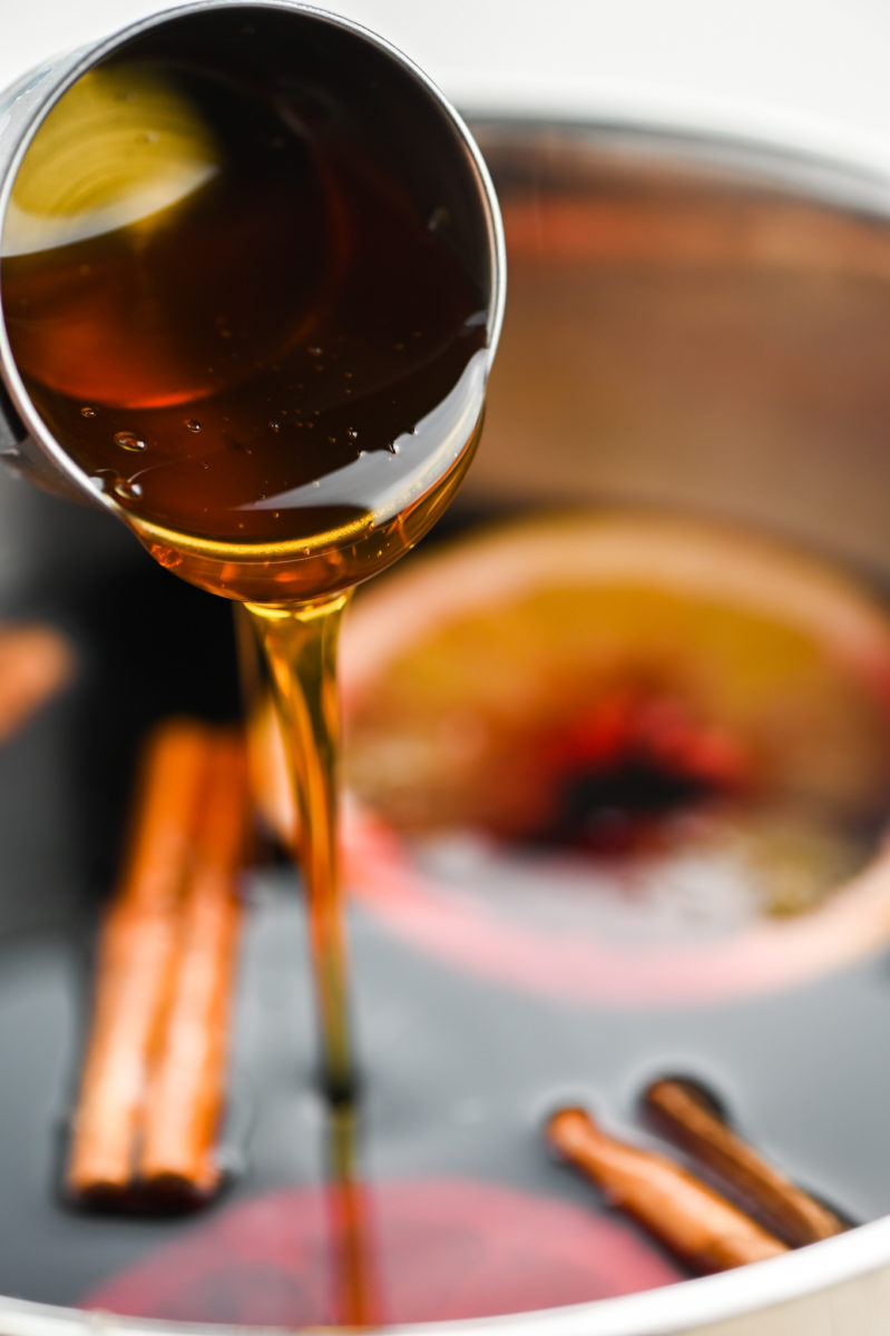 Adding honey to mulled wine. 