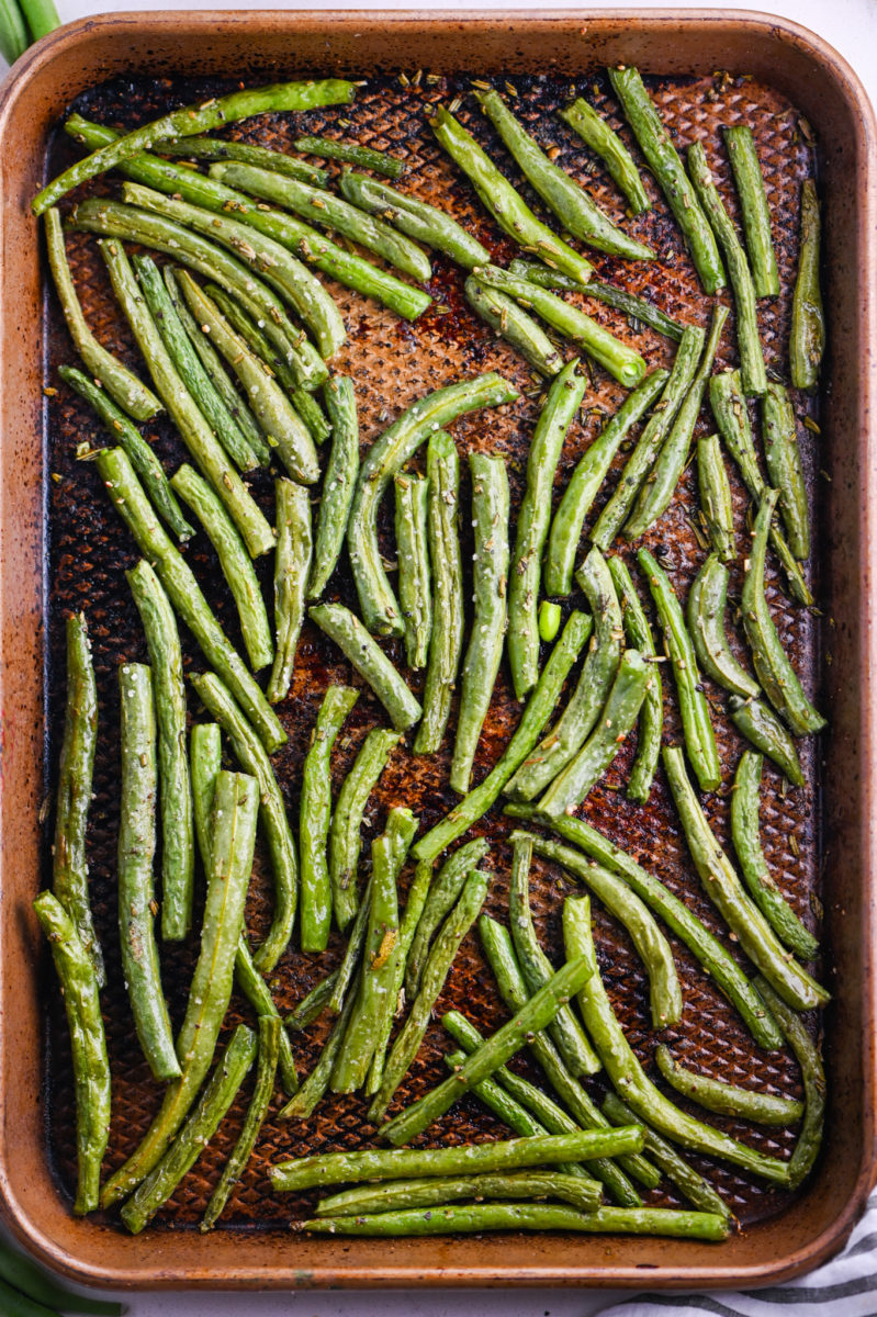 Oven roasted green beans on baking sheet. 