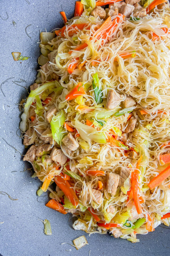 Filipino Pancit with pork and vegetables in a wok