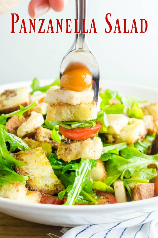 Panzanella Salad is a Tuscan salad with bread, tomatoes, herbs and a simple vinaigrette. It's the perfect way to enjoy summer tomatoes!  #vegetarian #salad #panzanella #italianfood #italianrecipe
