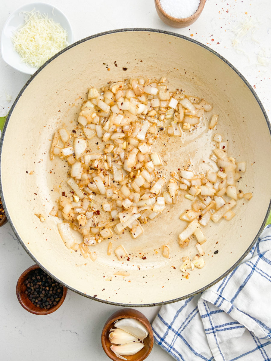 Onion, garlic and crushed red peppers sauteed in pan. 