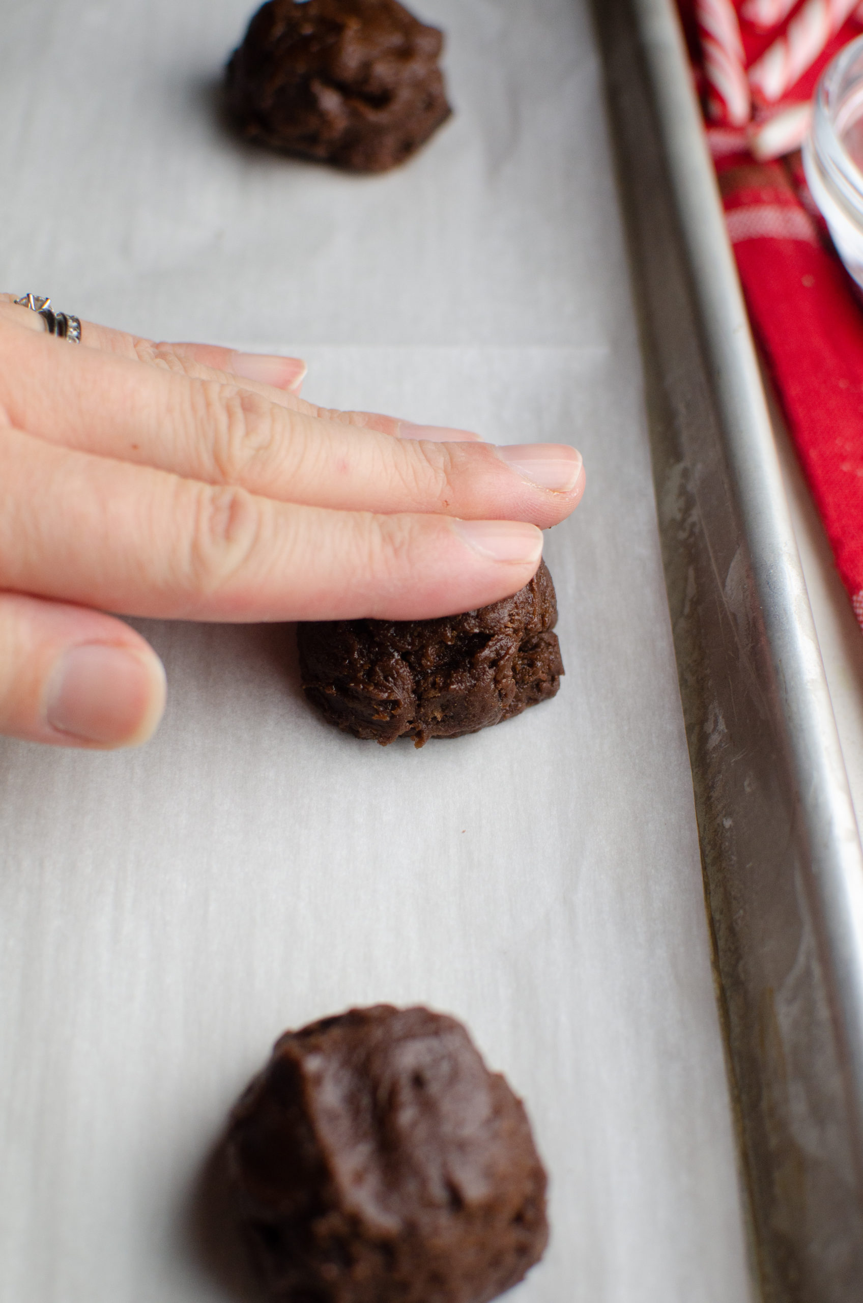 Flattening a cookie with hand. 