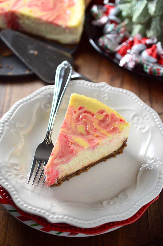 Luscious eggnog cheesecake is swirled with melted Hershey's Candy Cane Kisses in this Peppermint Eggnog Cheesecake making it a perfect holiday treat!