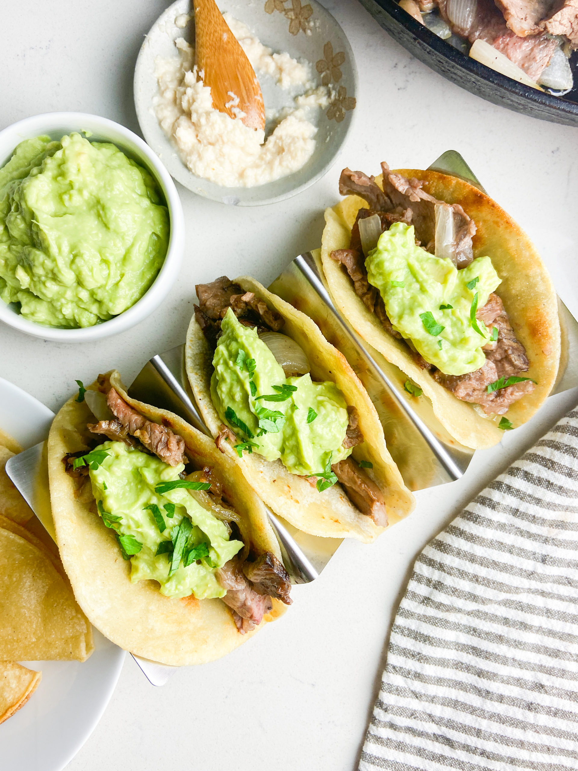 Overhead photo of 3 leftover prime rib tacos in a taco holder. 