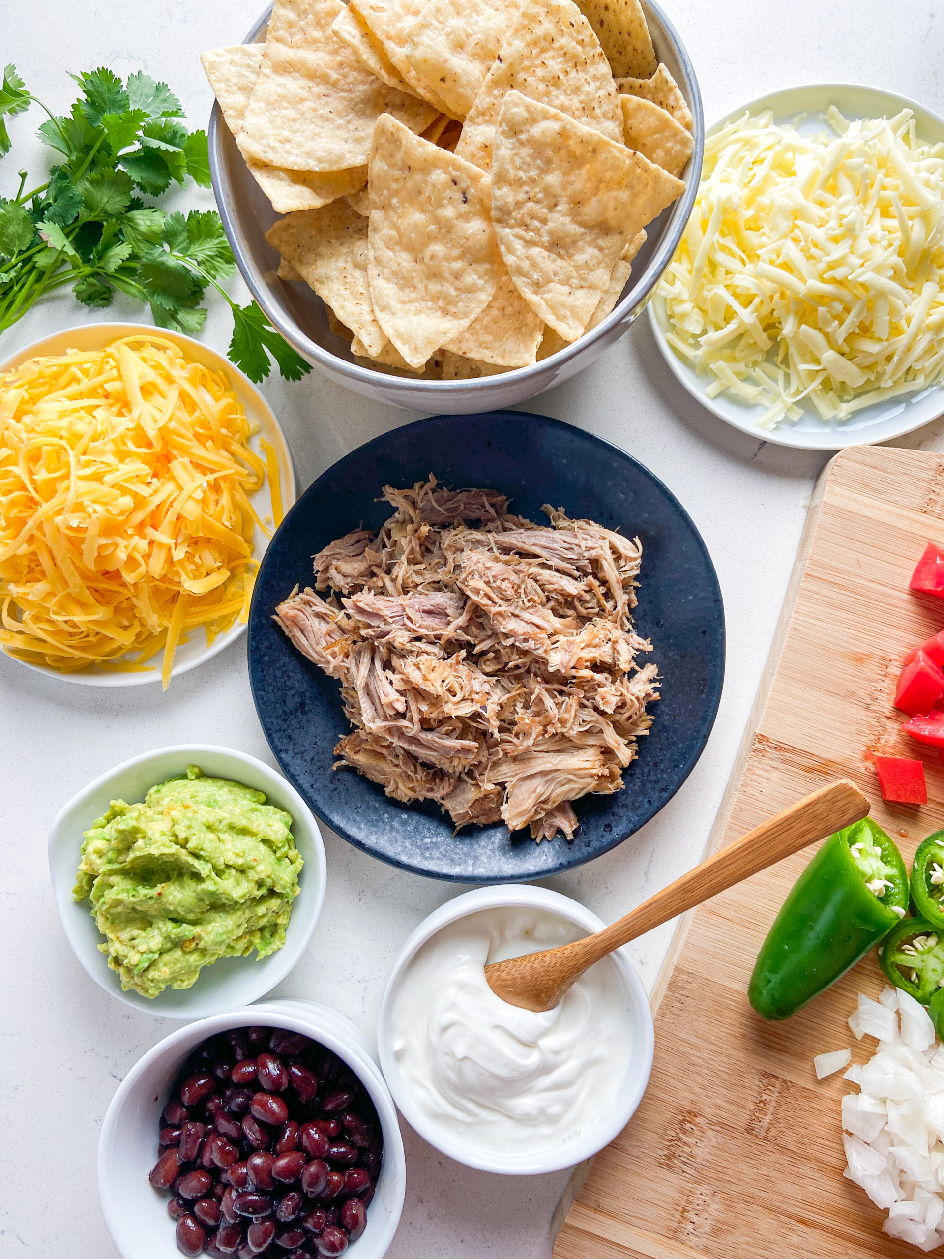 Overhead photo of ingredients  used to make pulled pork nachos. 