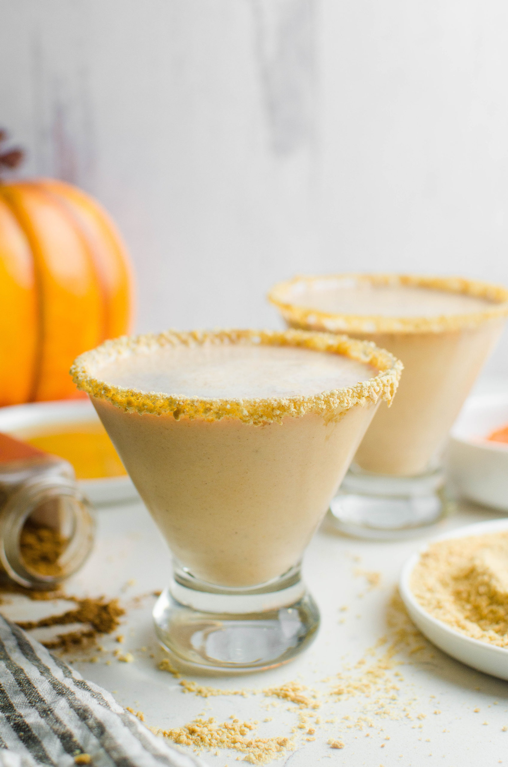 2 pumpkin martinis with a white background. 