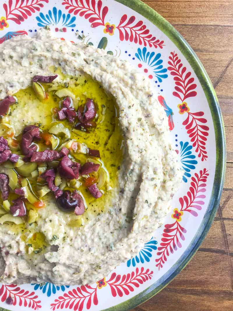 Quick olive hummus is a great twist on the classic snack. It's the perfect dip for parties or your afternoon snack session. 