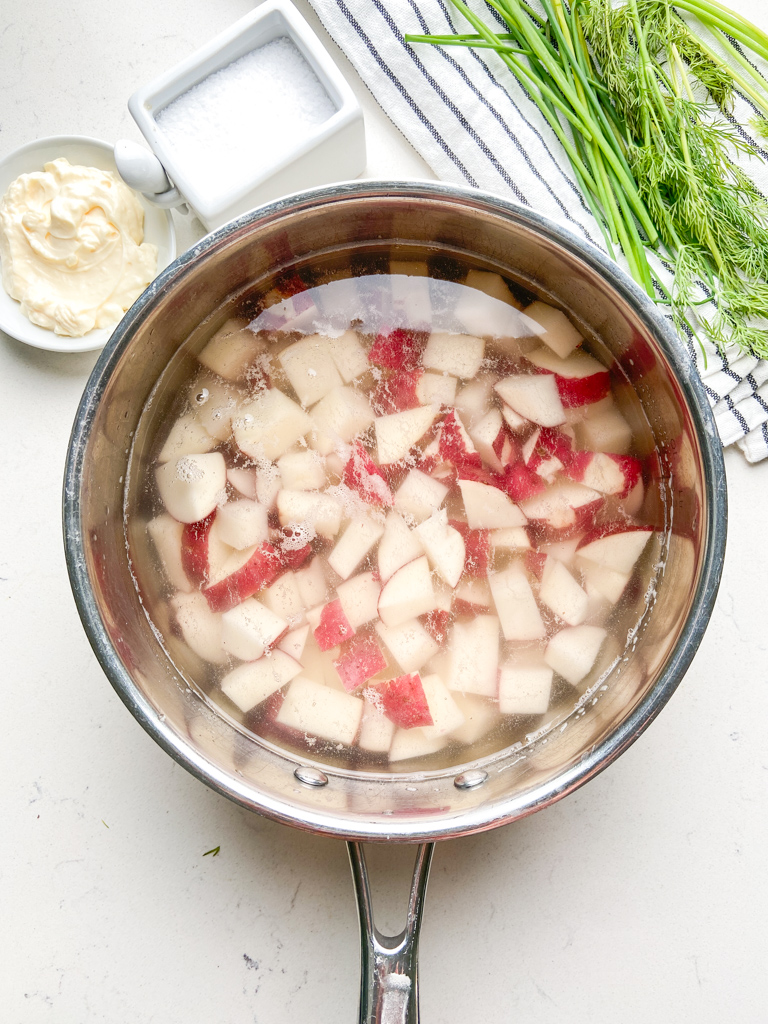 Boiling red potatoes in a pot. 