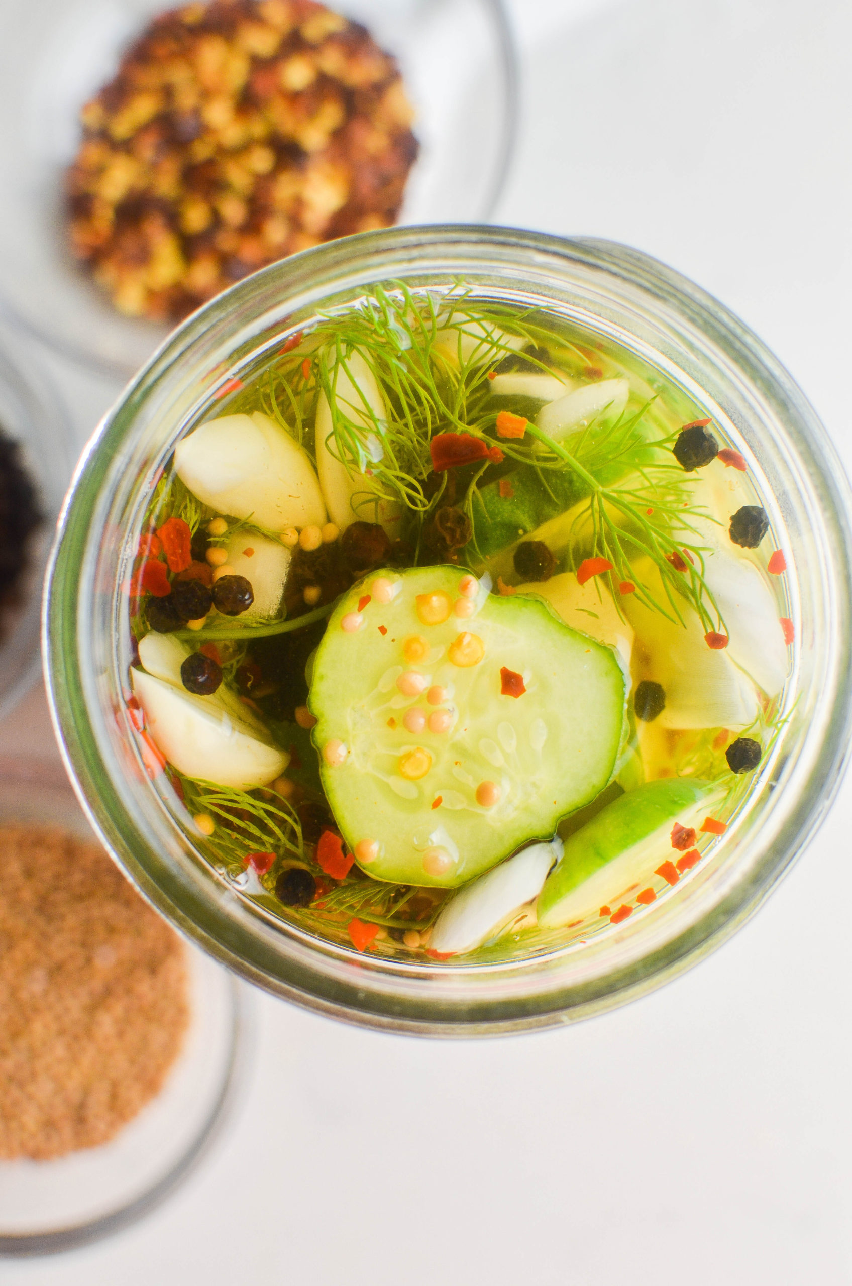 Overhead photo of pickle slices in a jar. 