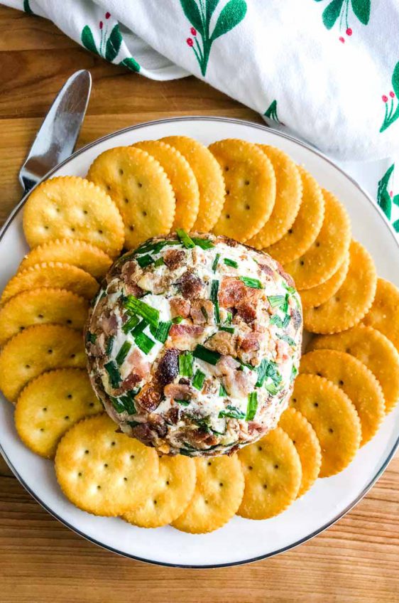 This Roasted Garlic Cheese Ball is a party must have. With Roasted Garlic, Bacon, Goat Cheese and Chives, this Easy Cheese Ball Recipe will be a favorite for years to come! 