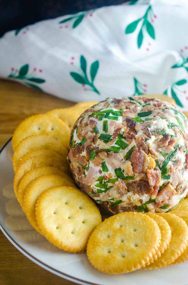 This Roasted Garlic Cheese Ball is a party must have. With Roasted Garlic, Bacon, Goat Cheese and Chives, this Easy Cheese Ball Recipe will be a favorite for years to come! 