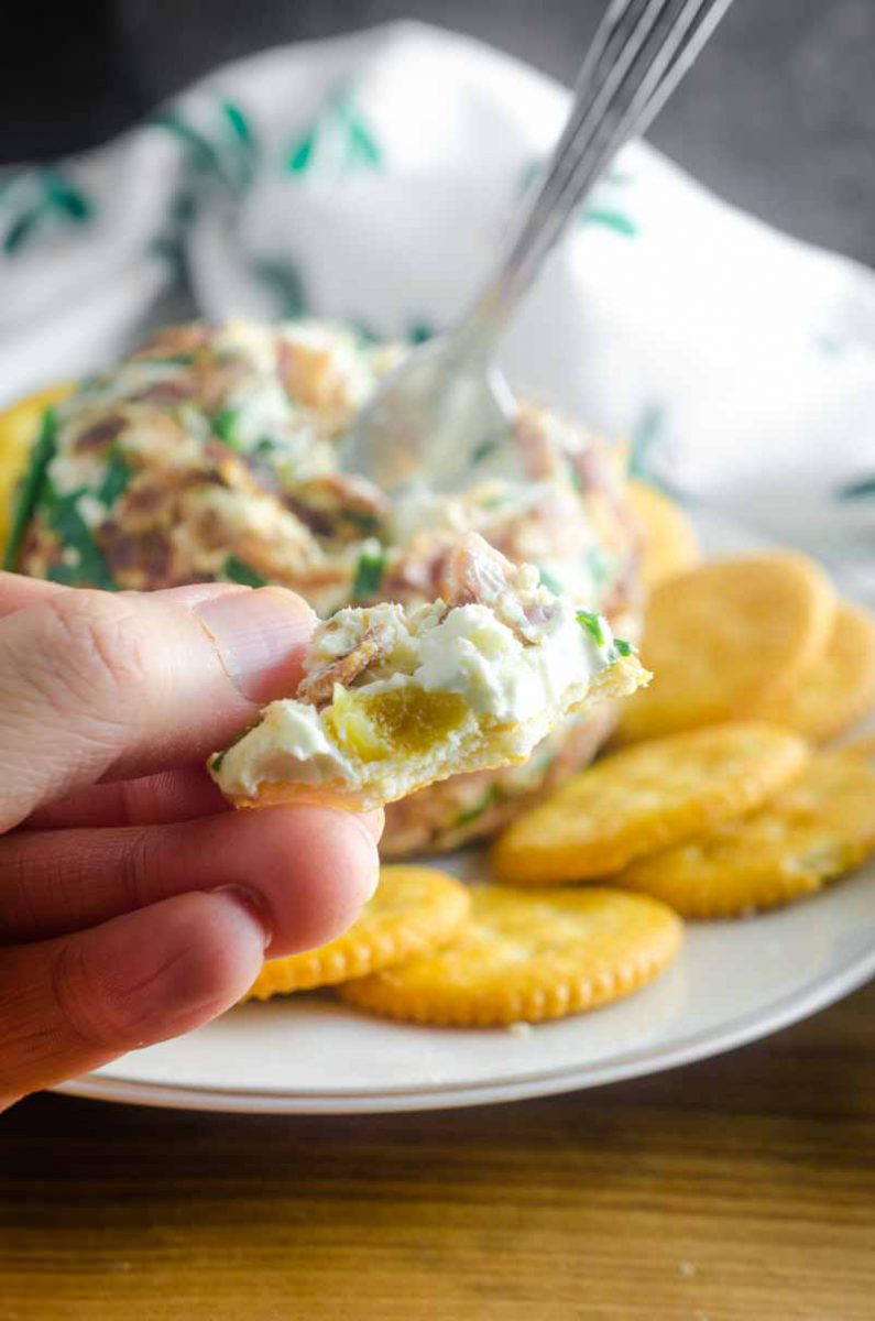 This Roasted Garlic Cheese Ball is a party must have. With Roasted Garlic, Bacon, Goat Cheese and Chives, this Easy Cheese Ball Recipe will be a favorite for years to come! 