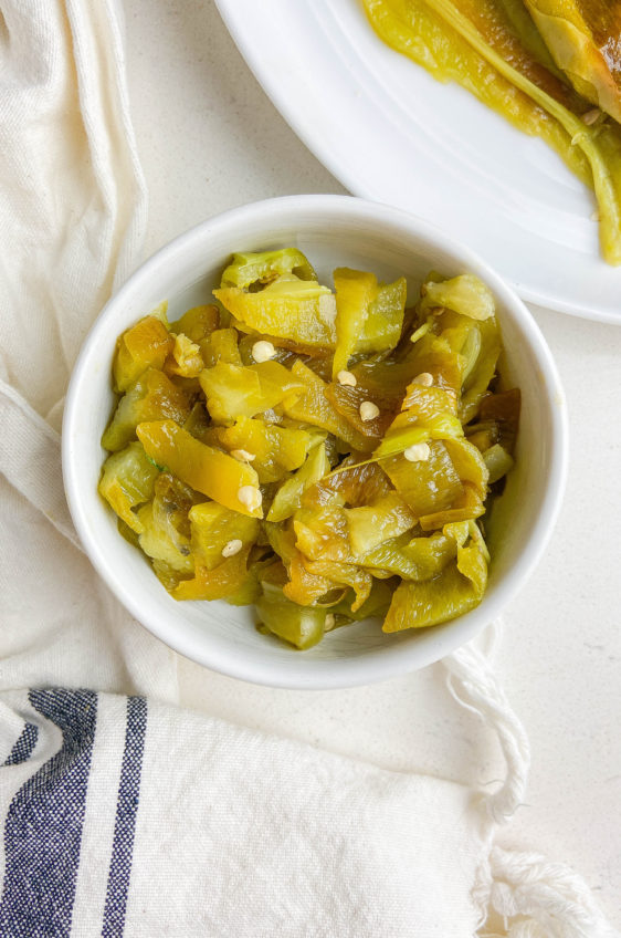 Diced green chiles in a white bowl.