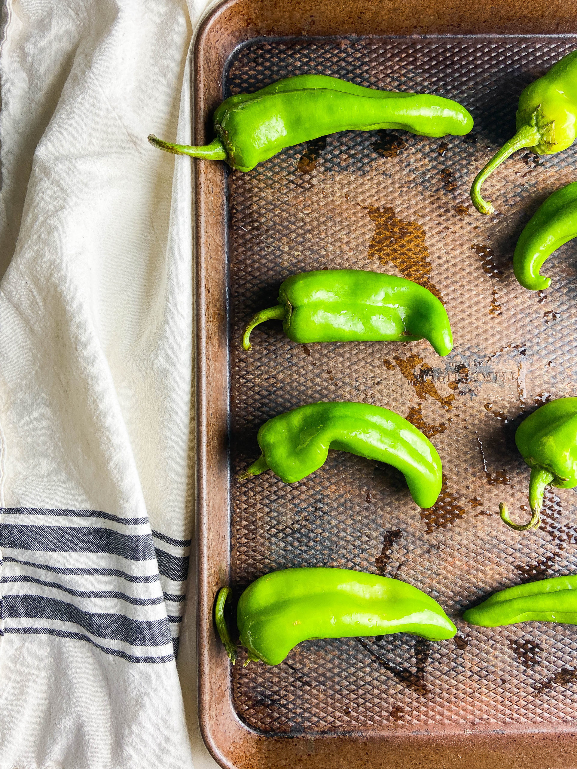 Green chiles on a baking sheet. 