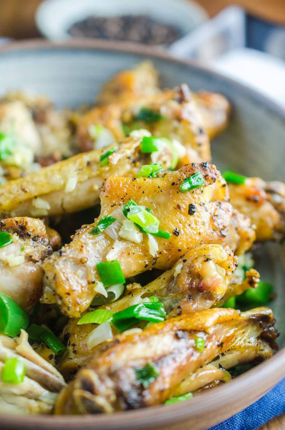 Baked Salt and Pepper Chicken wings are baked until crispy and tossed in a mixture of sesame oil, jalapeños, garlic and green onions.