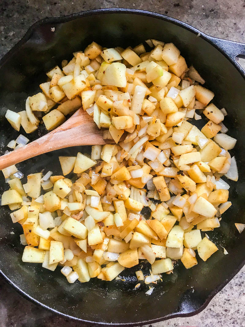 Sauteed apples and onions in a cast iron skillet. 