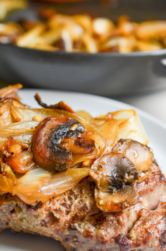 Sauteed mushrooms and onions on top of a steak.