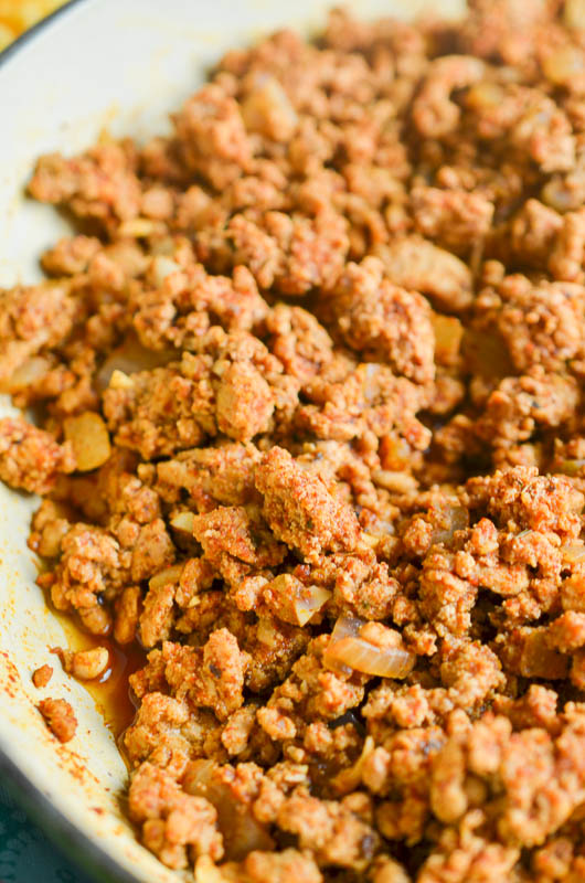 Side angle photo of seasoned taco meat in a pan. 
