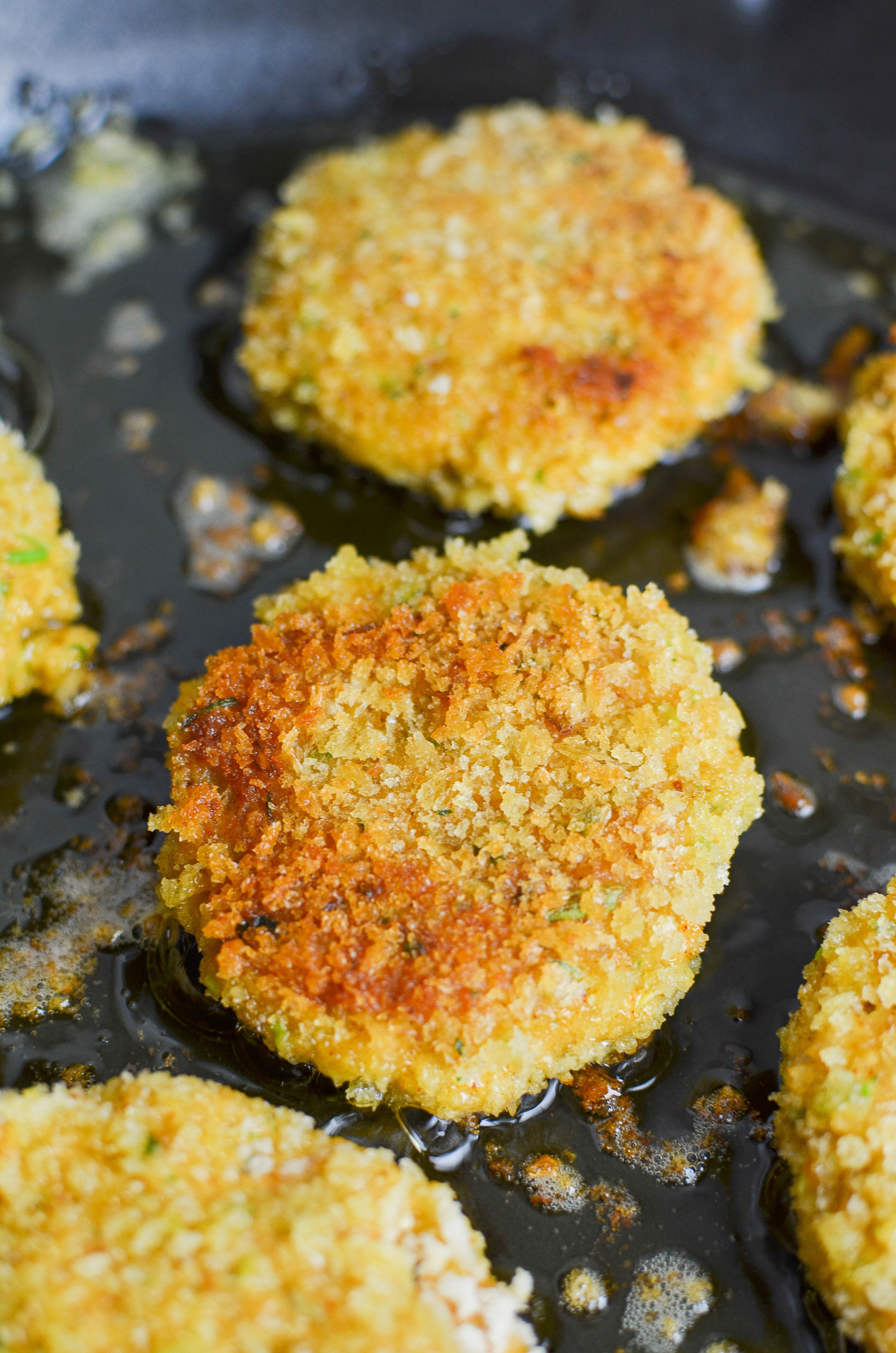 Frying cakes in cast iron skillet. 