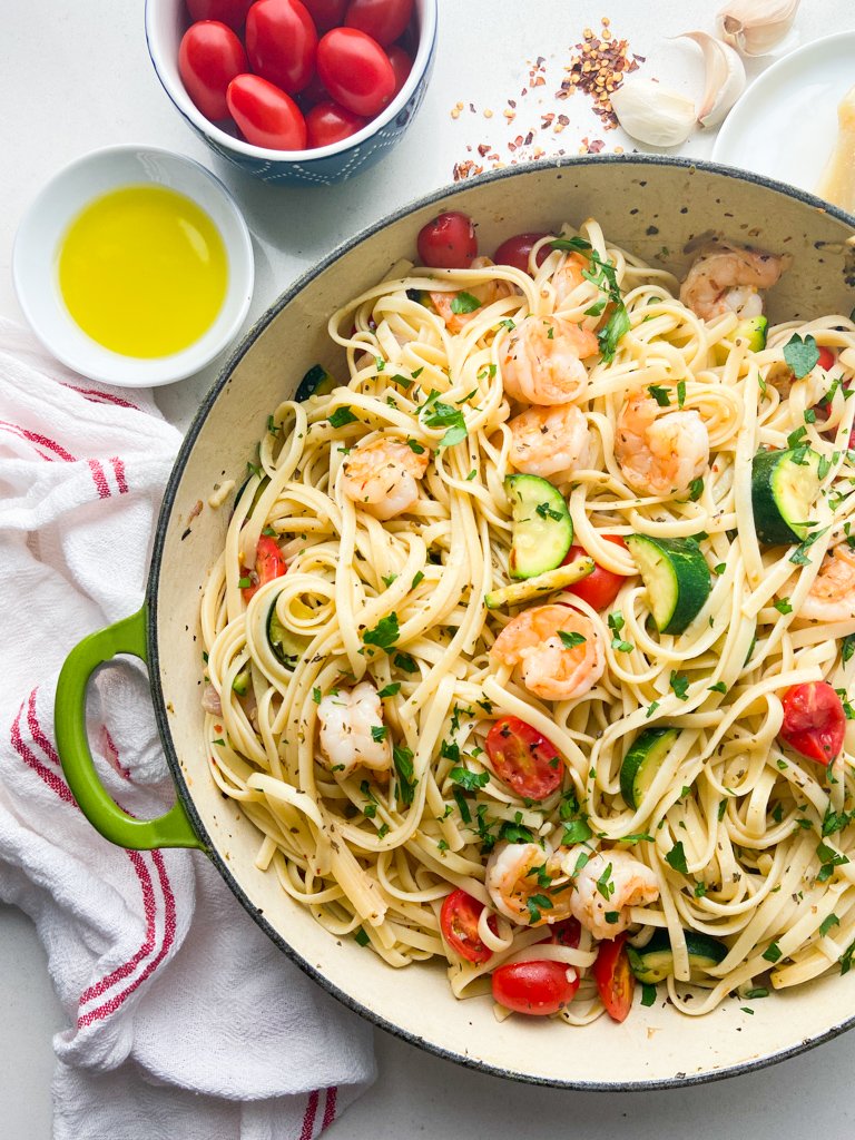 Overhead photo of shrimp linguine in a cast iron skillet. 