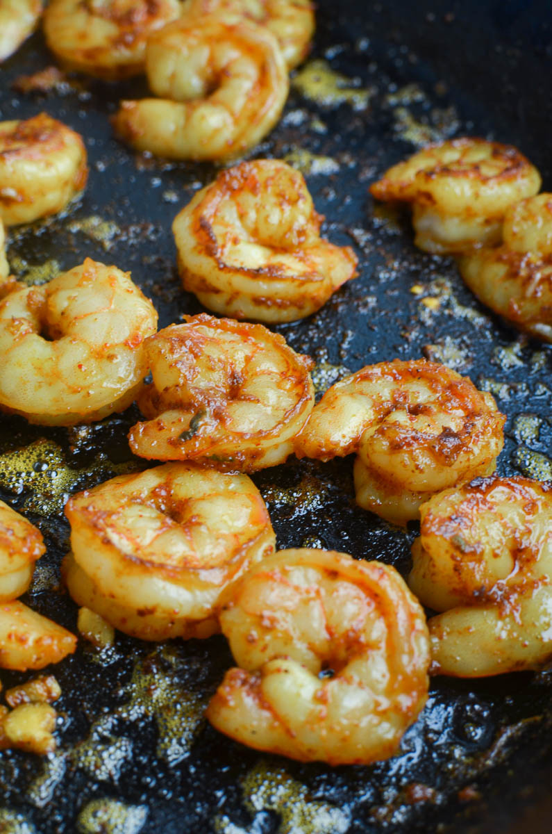 Shrimp cooking in a cast iron skillet. 
