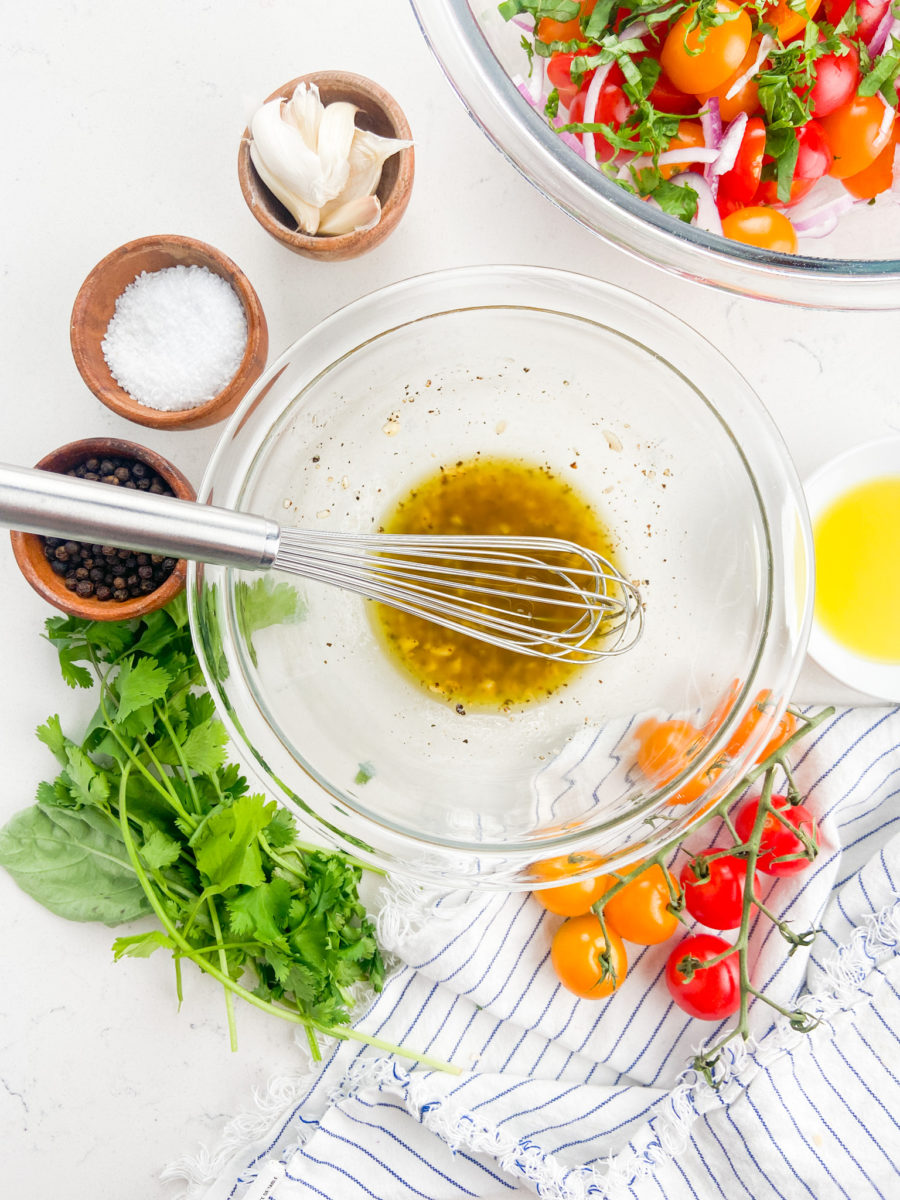 Dressing for tomato salad in glass bowl. 