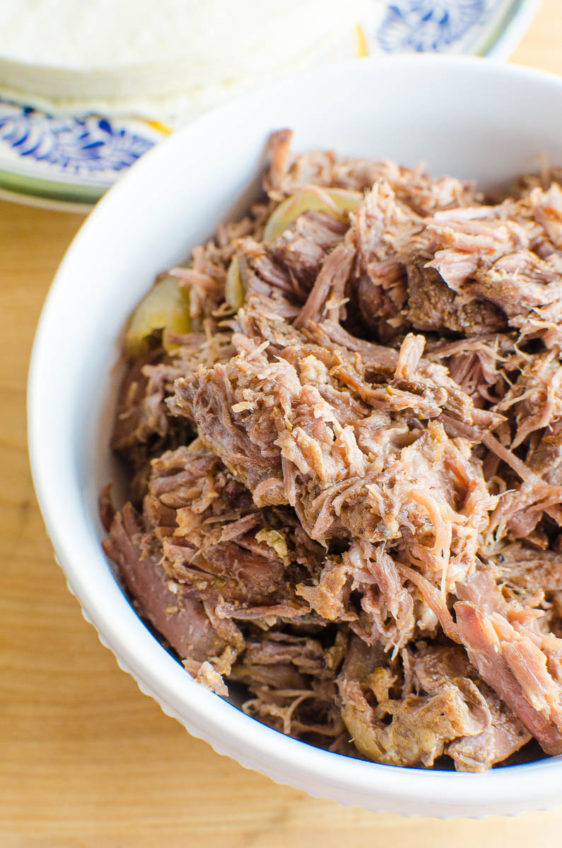 Shredded crockpot beef in a bowl.