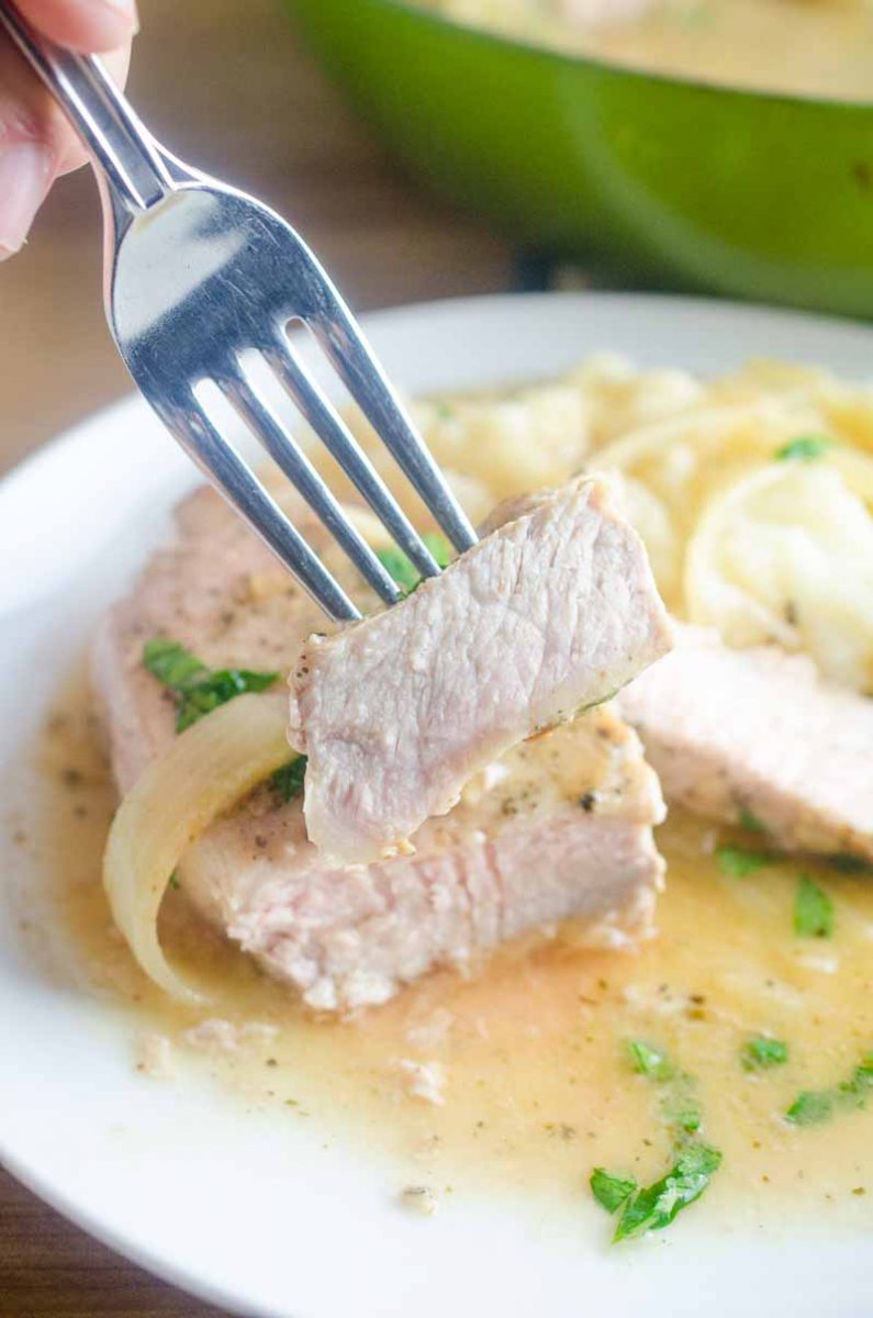 Smothered Pork Chops are a classic for a reason! These sage rubbed pork chops are pan fried and simmered in a savory onion gravy. It's comfort food at it's finest! 