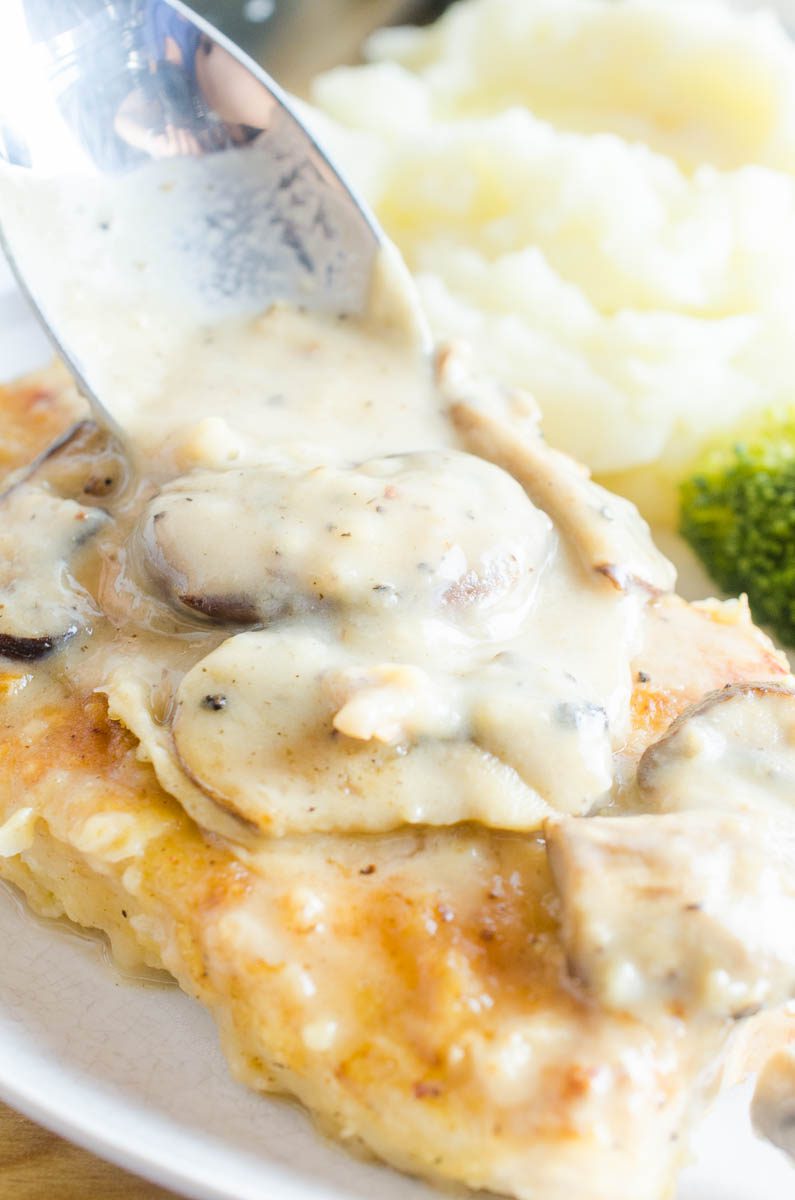 Spooning pan gravy on southern fried pork chops. 