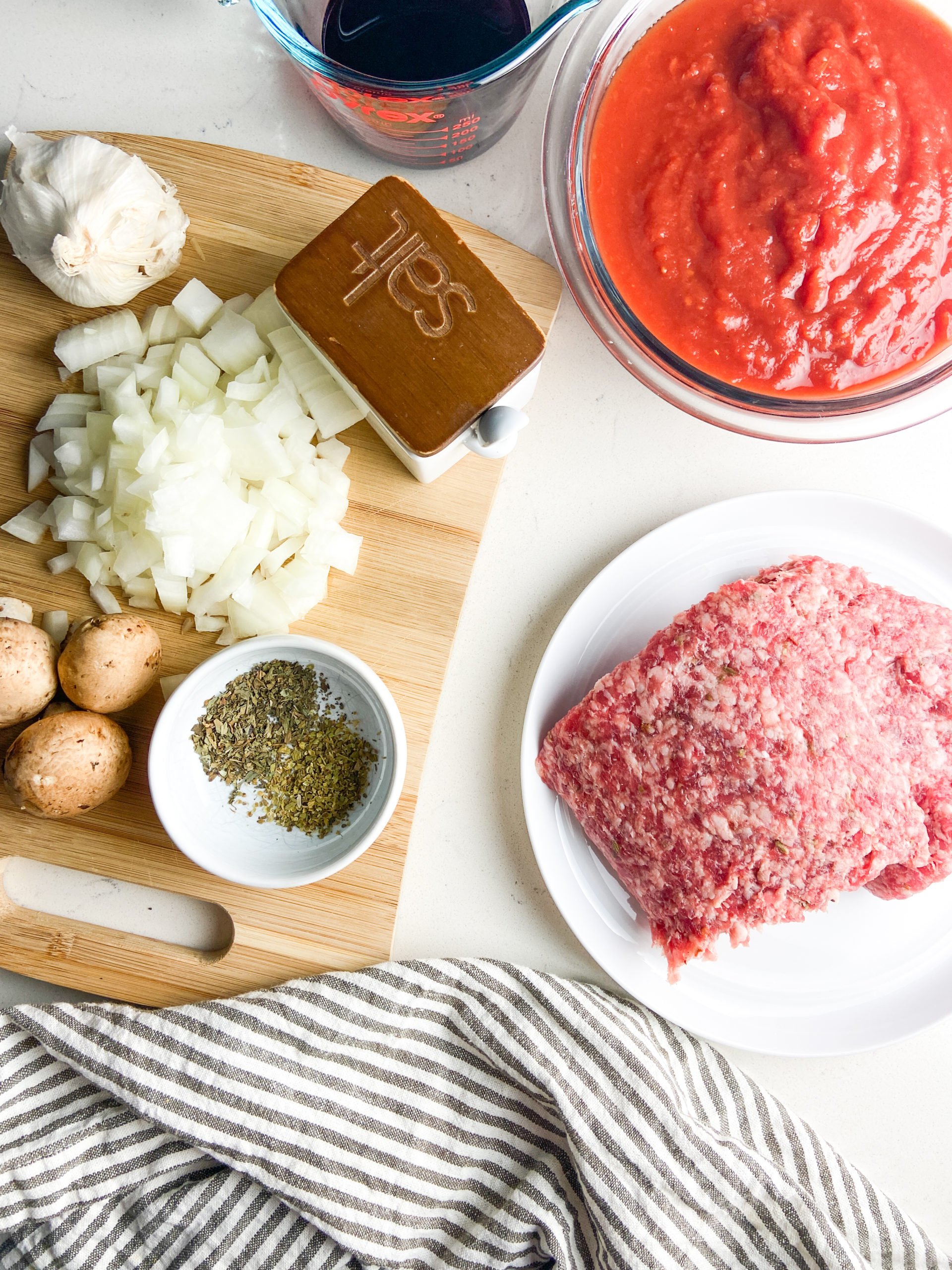 Overhead photo of ingredients for spaghetti with meat sauce. 