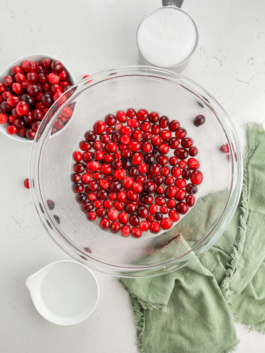 Soaking cranberries in simple syrup. 