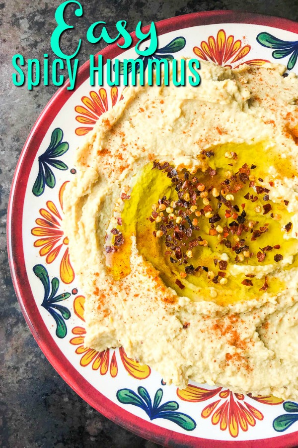 A kicked up version of traditional hummus with lime, crushed red pepper and cayenne. Spicy Hummus is a great addition to your party dip spread. #hummus #vegetarian #appetizer #vegan 