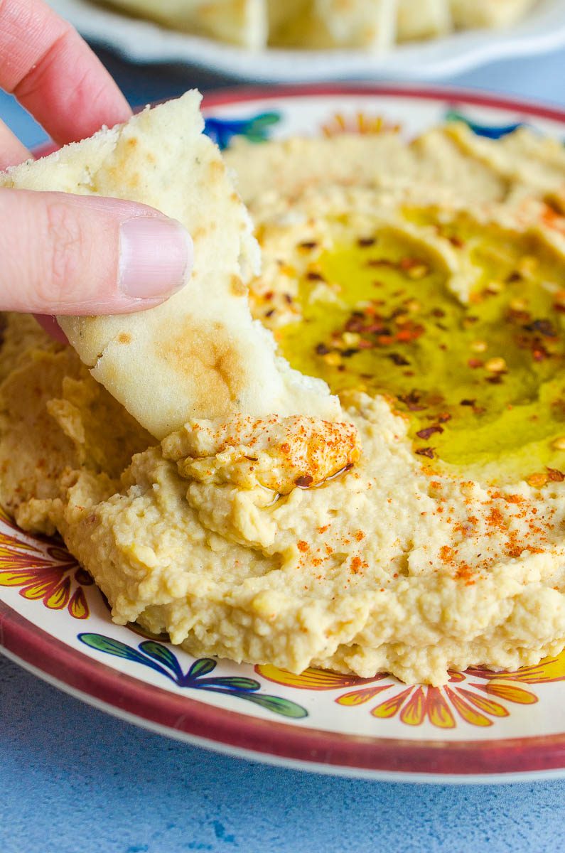 Pita dipped in hummus