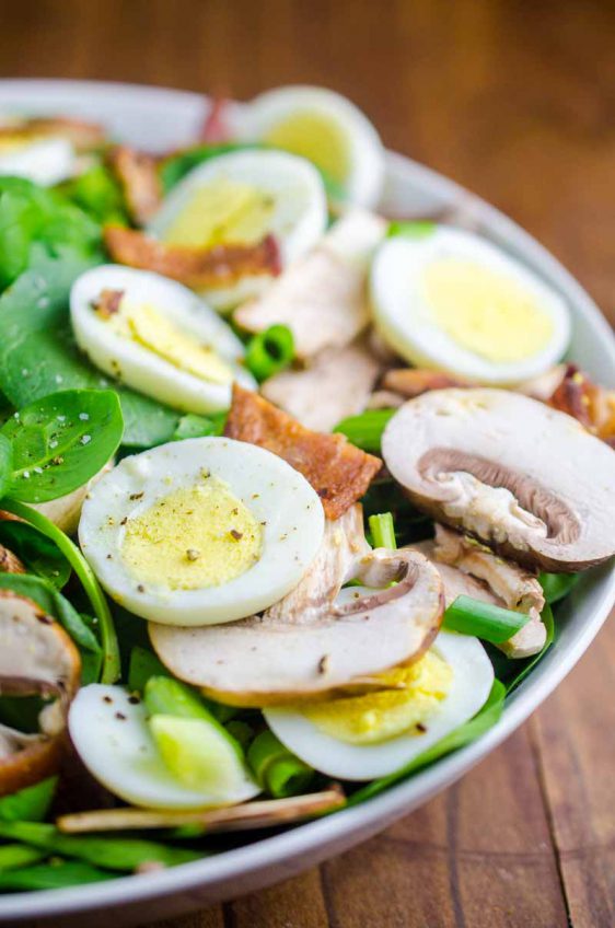 Spinach Salad with Bacon Dressing is a classic for a reason. Fresh spinach tossed with mushrooms, crispy bacon, hard boiled eggs and tossed with a warm bacon dressing. 