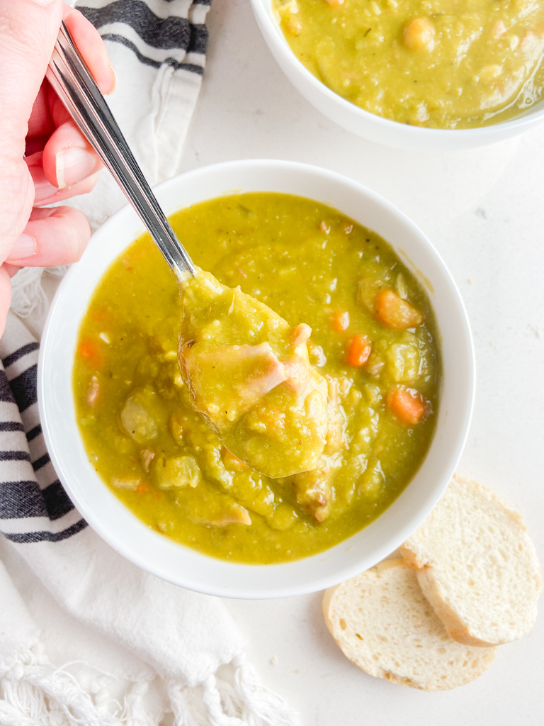 Overhead of photo of a spoonful of split pea soup. 