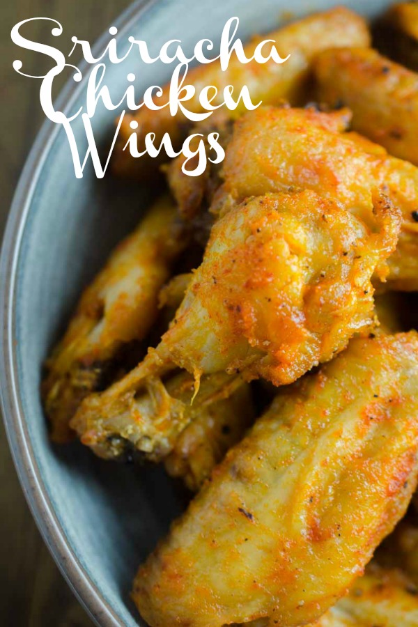 Sriracha Chicken Wings are baked to perfection and then tossed in a spicy sriracha sauce. They will be your new favorite chicken wing! #chickenwings #sriracha #bakedchickenwings #chicken