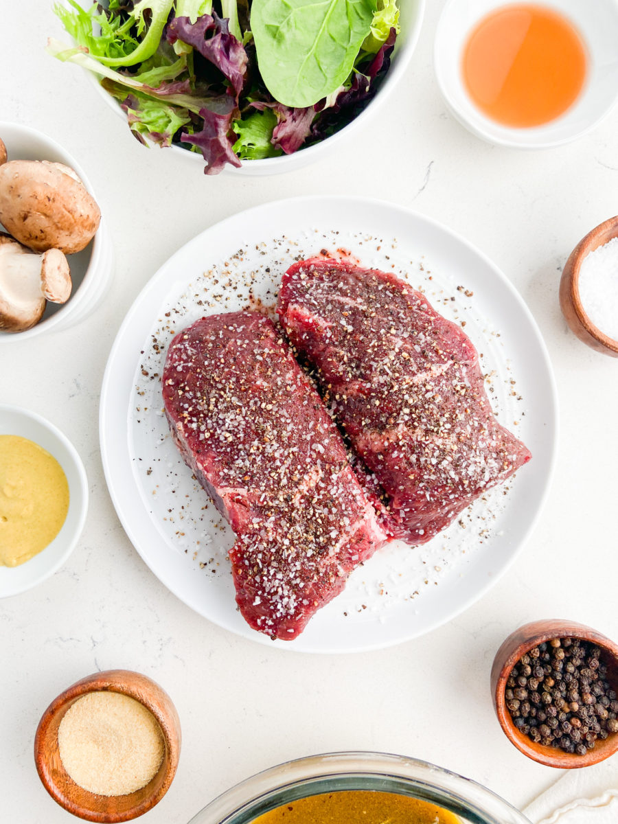 Top sirloin steaks seasoned with salt and pepper. 